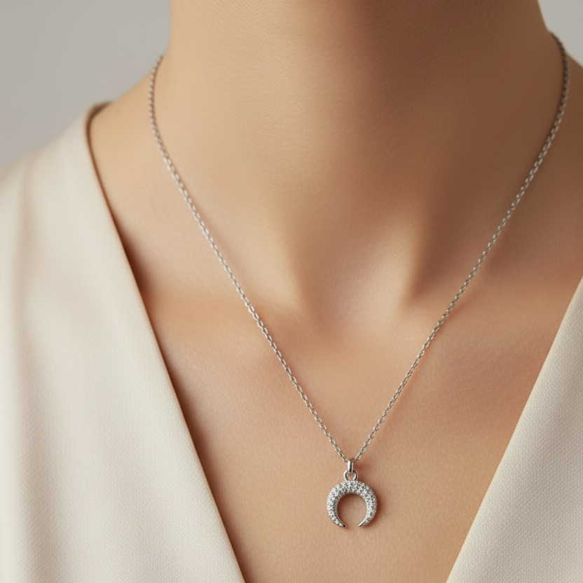 Zircon-studded half-moon necklace in silver and gold